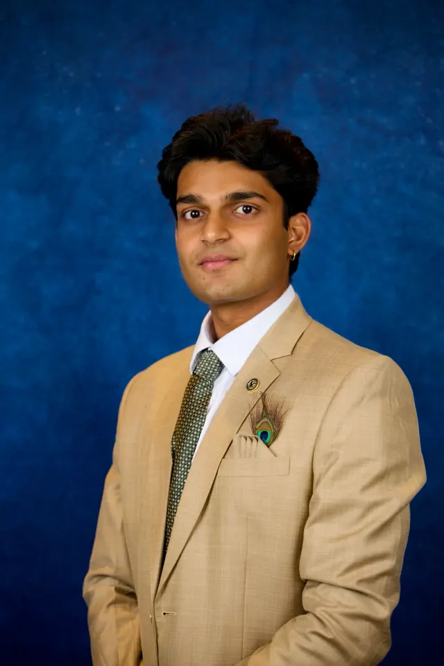 Portrait of Haitish Gandhi in a tan suit